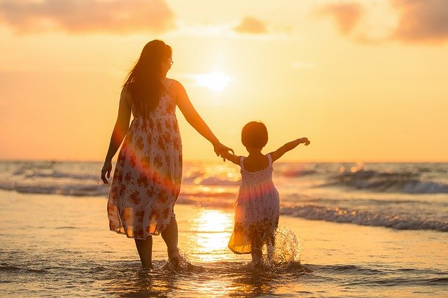 DELA Uitvaartverzekering - vergelijken en afsluiten - moeder met kind op het strand